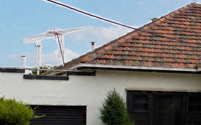 The same crop, where the aerial and the power line have a white outline against a bright blue sky